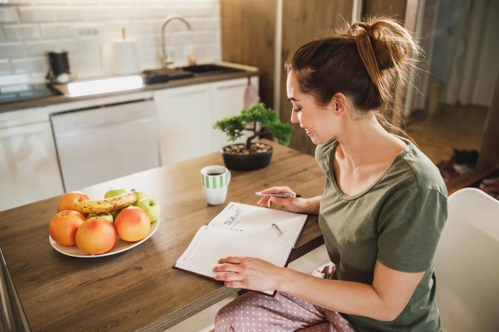 Home cook organizing recipe notes at a kitchen table